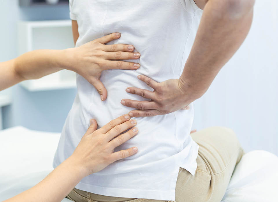 woman-with-hands-on-her-back-osteoporosis
